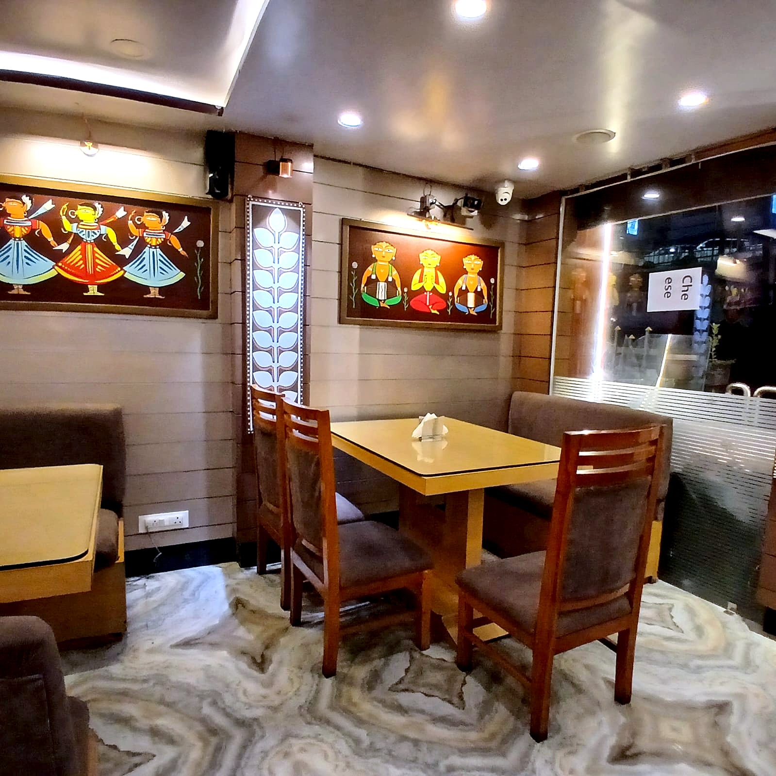 A corner table at Clubside Restaurant beneath framed artwork