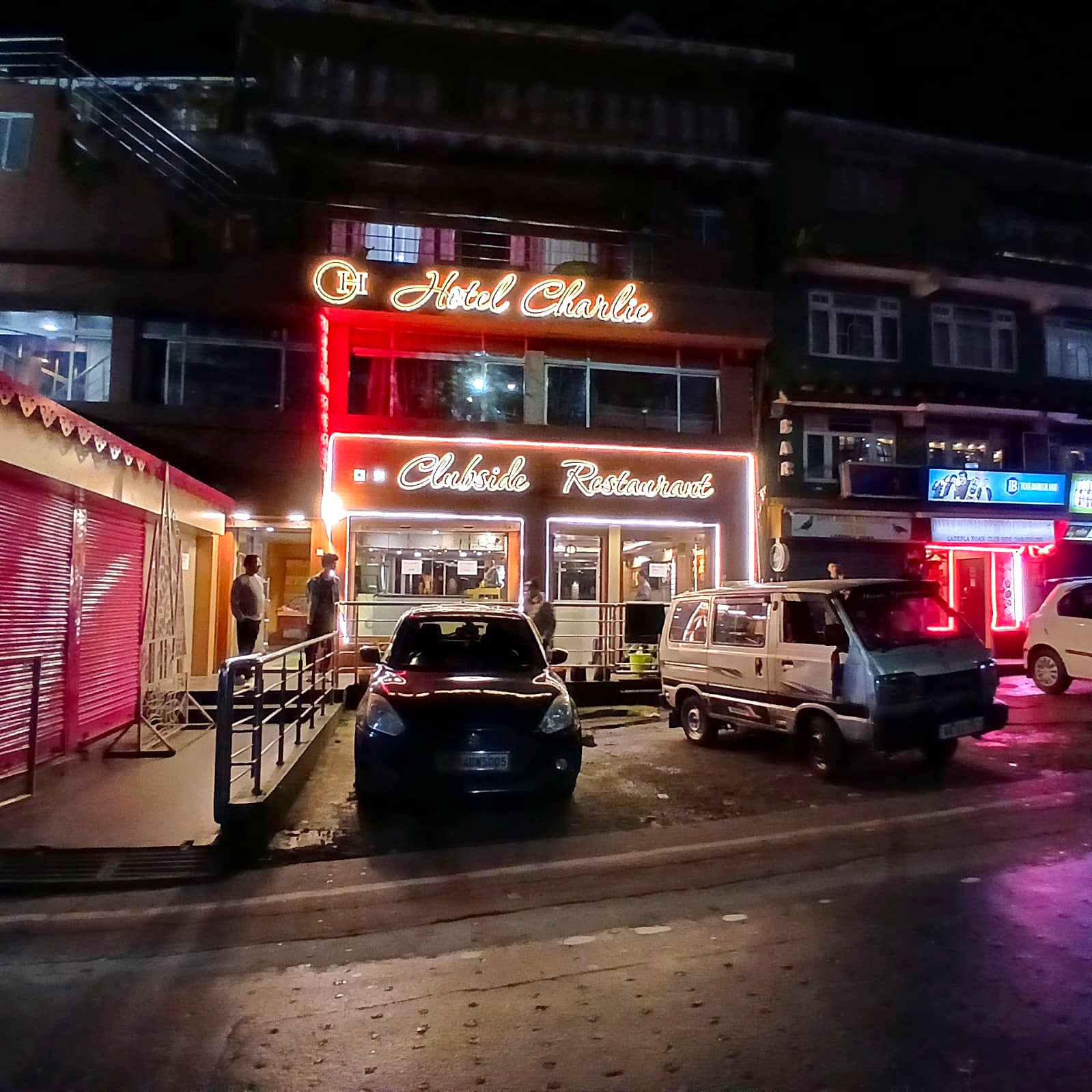 Hotel Charlie and Clubside Restaurant lit up at night, seen from Laden La Road